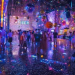 a vibrant party atmosphere comes alive as guests joyfully pose with playful props in front of dazzling photo booths, surrounded by bursts of colorful lights and shimmering confetti that capture the essence of celebration.