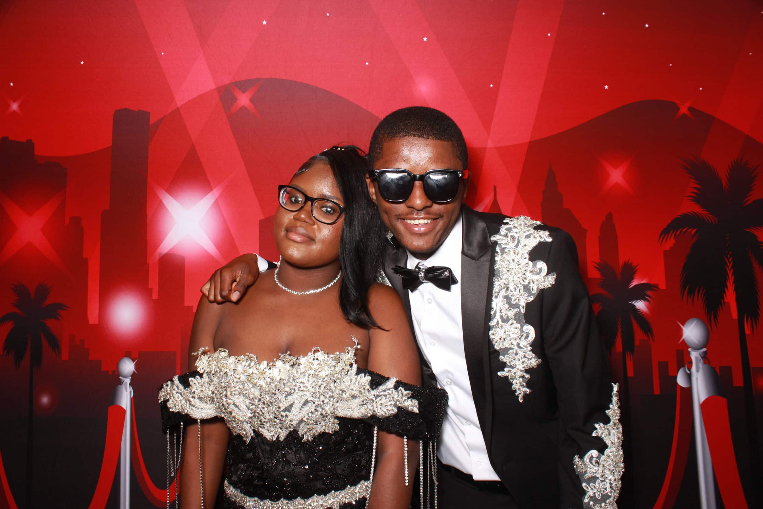 High school students enjoying a photo booth at a prom event