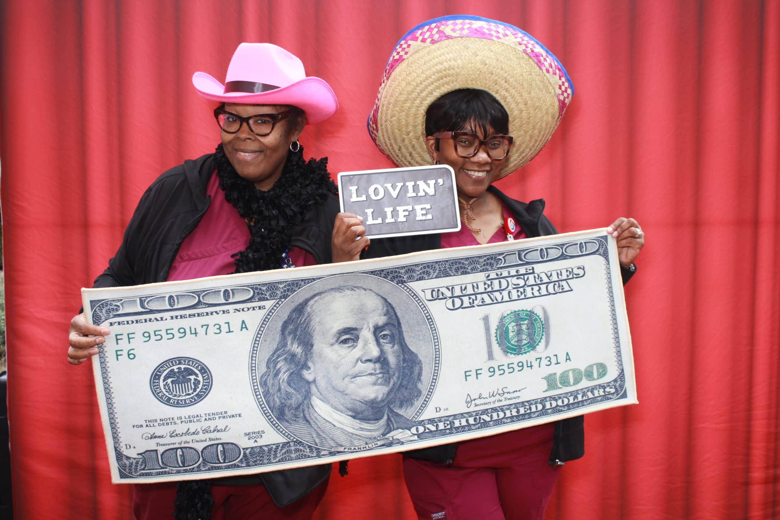 High school students enjoying a photo booth at a prom event