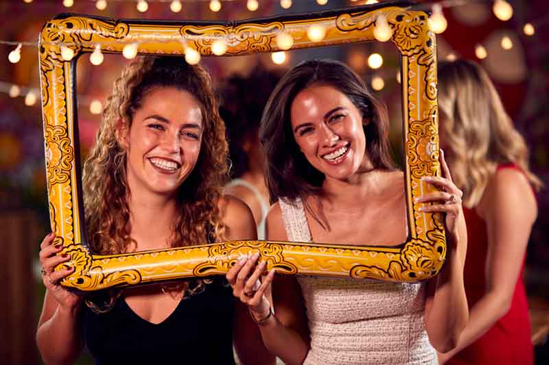 female friends having fun posing with photo booth 2024 10 19 10 47 34 utc