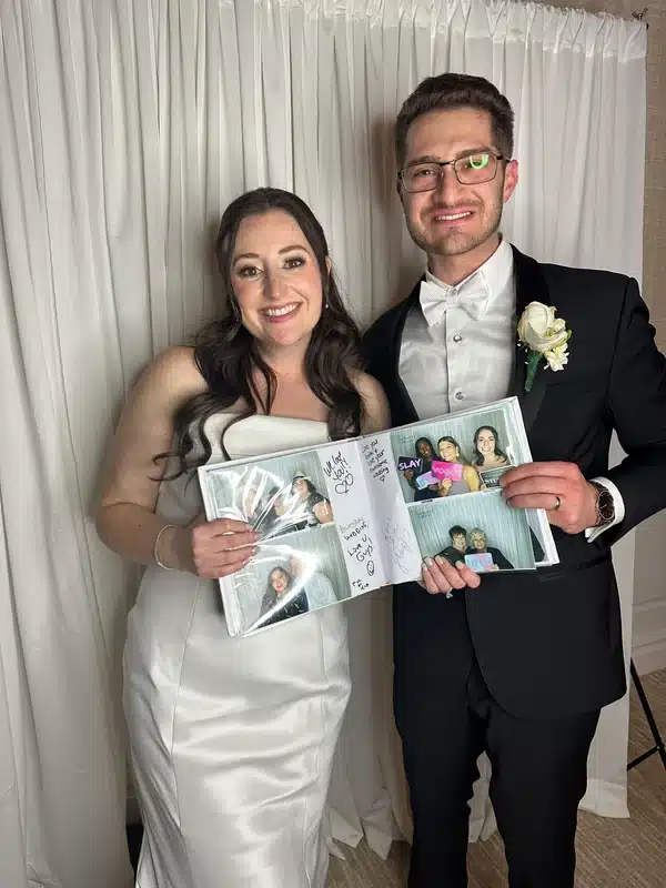 Photo booth scrapbook filled with guest photos and handwritten messages